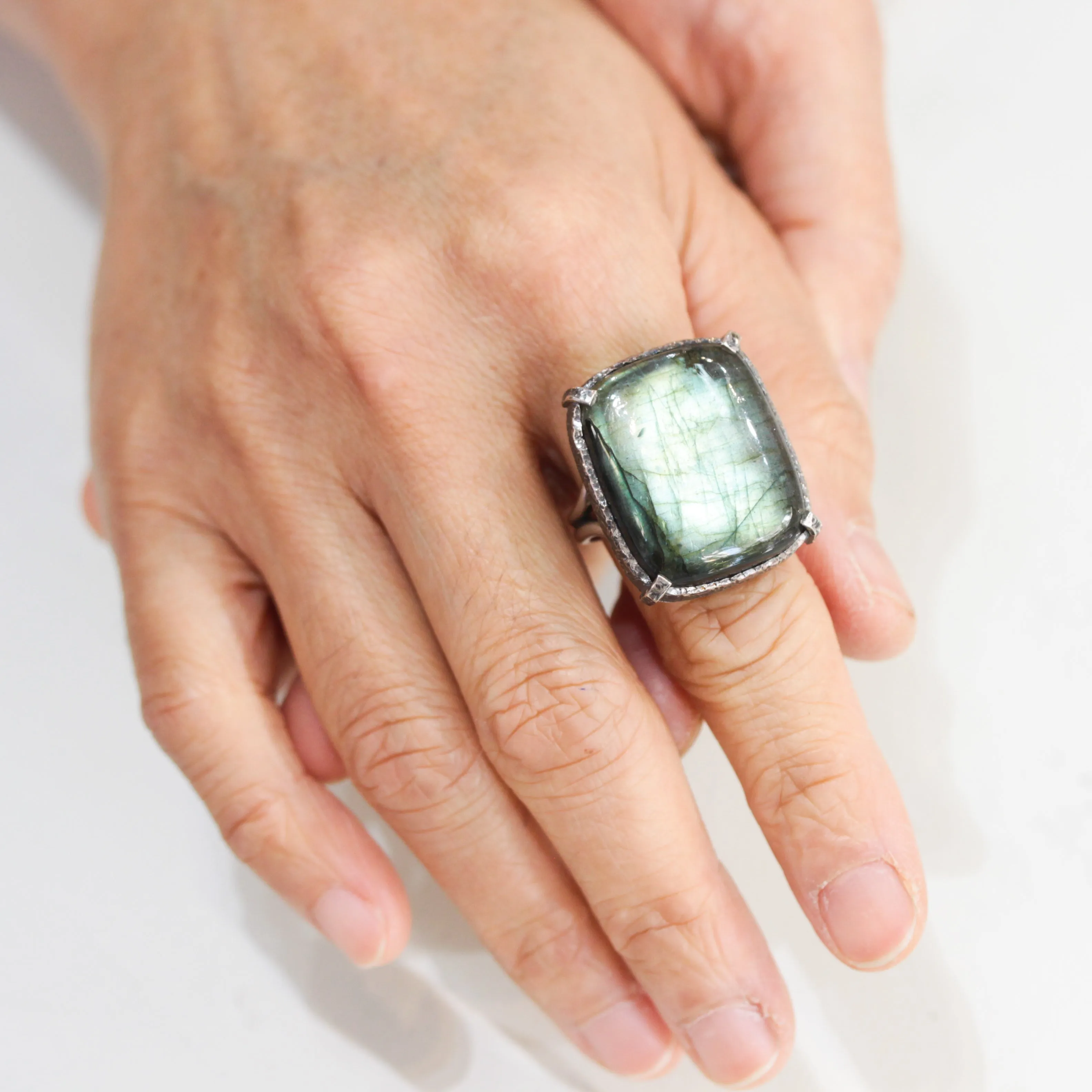 Rectagle cabochon Labradorite cocktail ring in silver bezel and prongs setting with sterling silver band