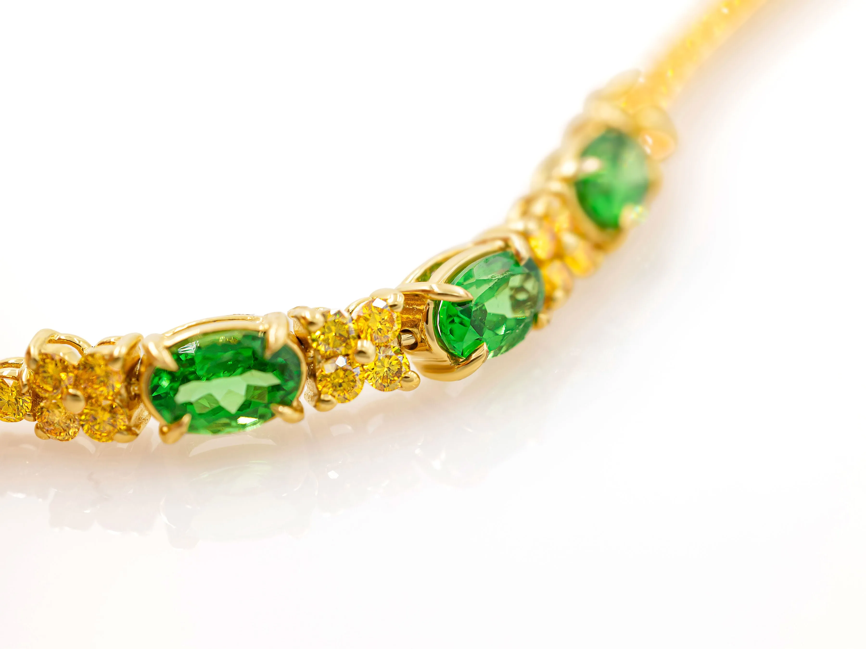 Tsavorite and fancy yellow diamond tennis bracelet